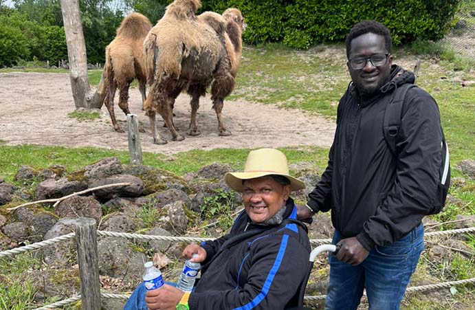 Afbeelding van twee vluchtelingen met op achtergrond kameel